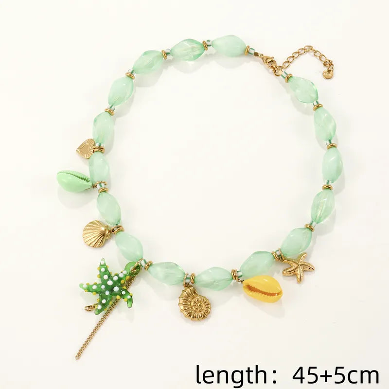 Necklace gold steel with green acrylic and starfish-