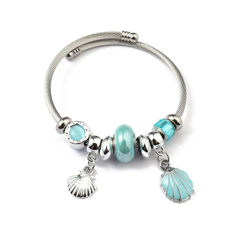 Βραχιόλι ατσάλινο bangle με γαλάζια charms και κοχύλι -BR392