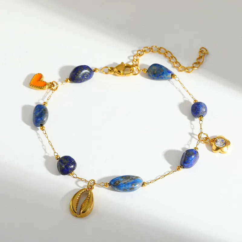 Βραχιόλι ατσάλινο με κοχύλι και μπλε πέτρες - BR526