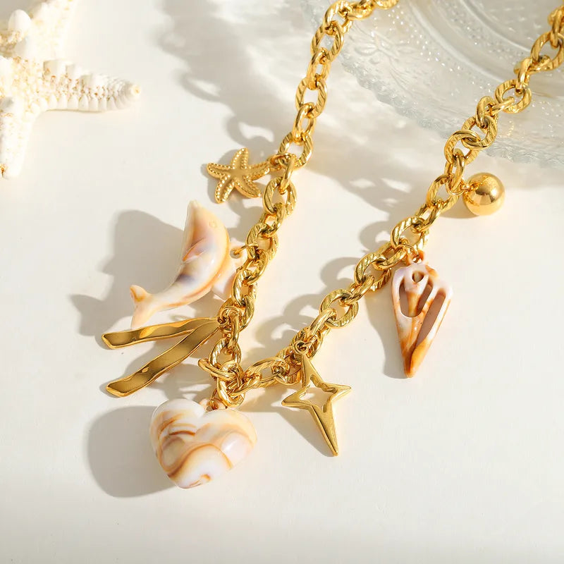 Necklace gilded steel with acrylic dolphin shell and heart-