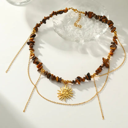 Collar de acero con piedras marrones y sol - NE667