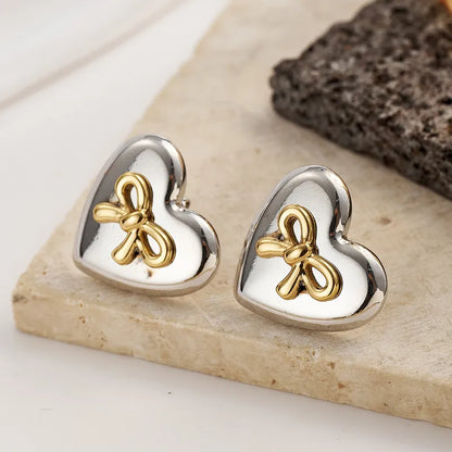 Σκουλαρίκια ατσάλι καρδιά με χρυσό φιόγκο-EA392