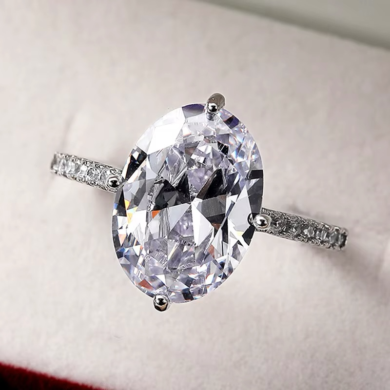 Silver ring with central oval zircon and perimeter zircon - R176