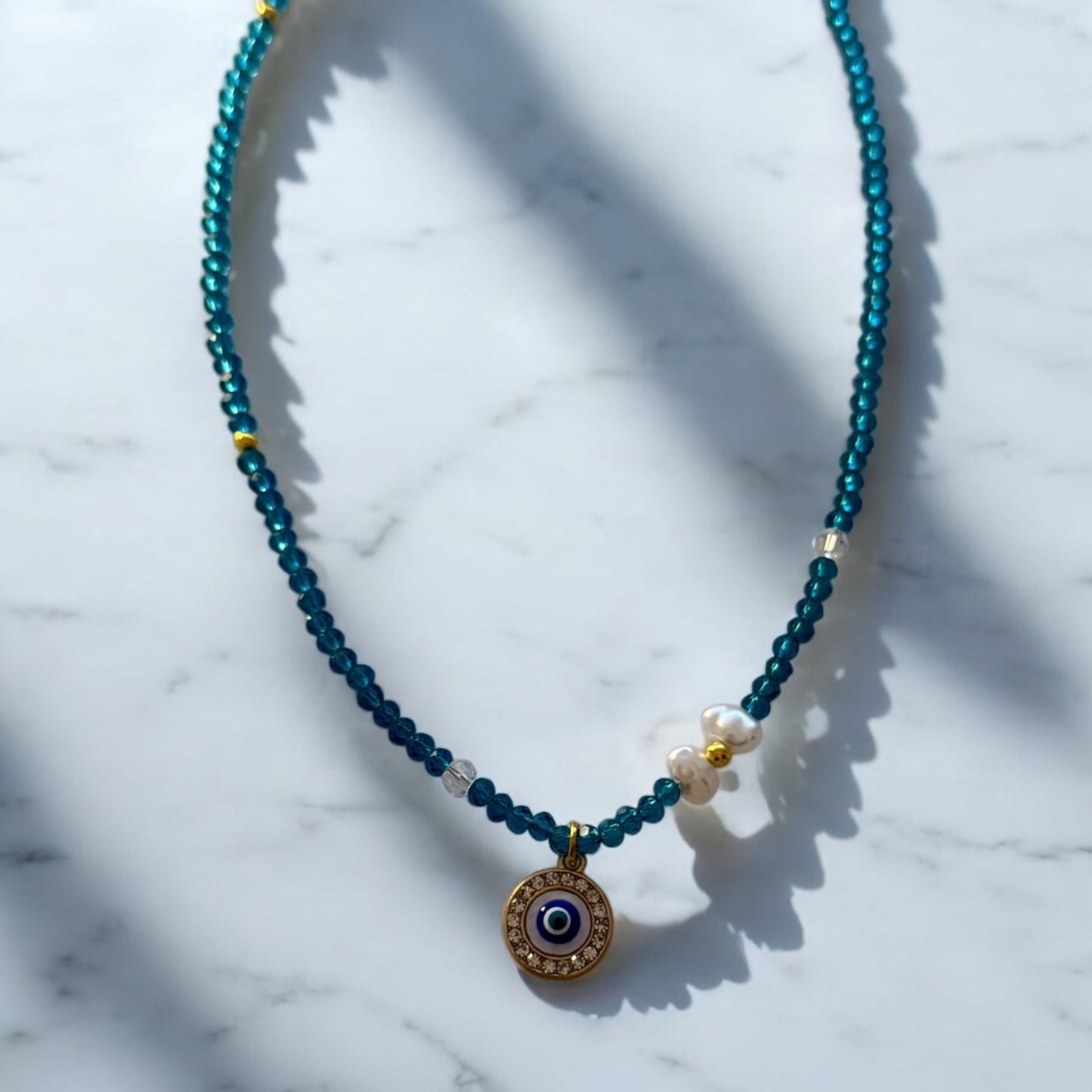 Necklace with blue beads and pendant eyes - ne429