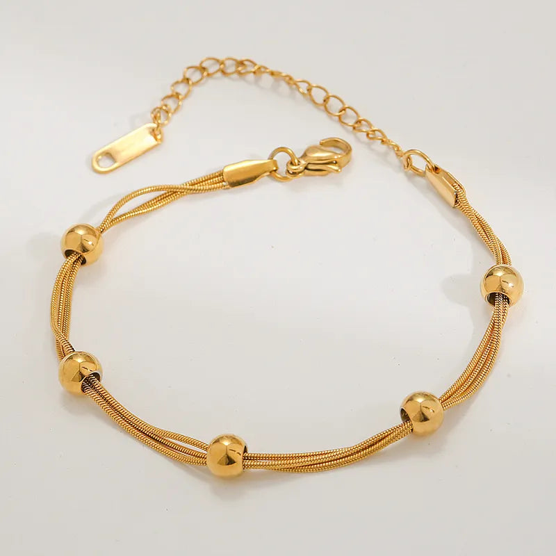 Pulseira de aço banhado a ouro com contas douradas-BR086