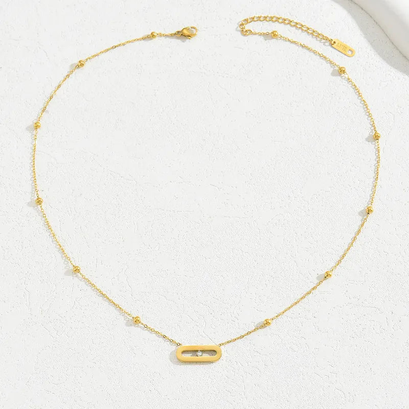 Colar tensor em aço dourado com oval e pedra no centro-NE031